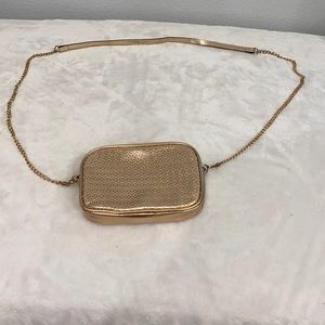 This is a rose gold cross body purse